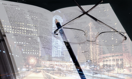 open book with glasses and pencilの写真素材