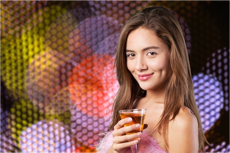 Photo of a beautiful woman having martini in outdoor restaurant, celebration party, city nightlife lifestyle, glamorous lady with drink, female enjoying cocktailの写真素材