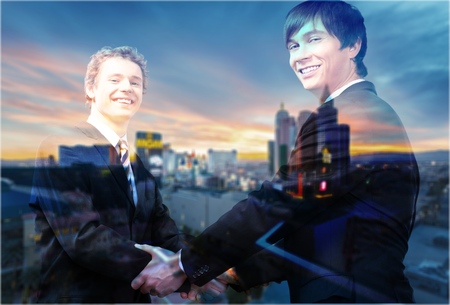 Double exposure of business women double handshake and city in a foggy morning on zoom background as...