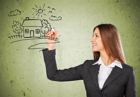 Cute woman sketching city and graph icons and symbolsの写真素材