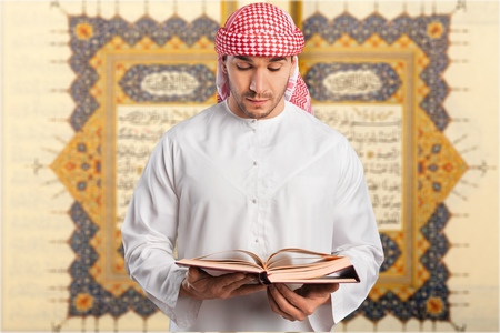 A senior cleric is portrayed with a book in his hands.の写真素材