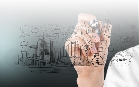 Back view of businessman drawing sketch on wallの写真素材