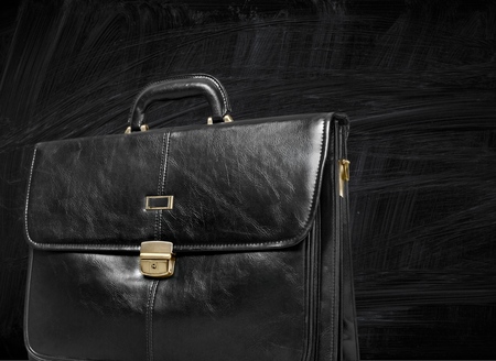 Brown leather briefcase with brass buckle, isolated on white background