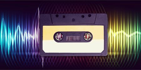 yellow retro Cassette tape over blackboard. top view. music sketches