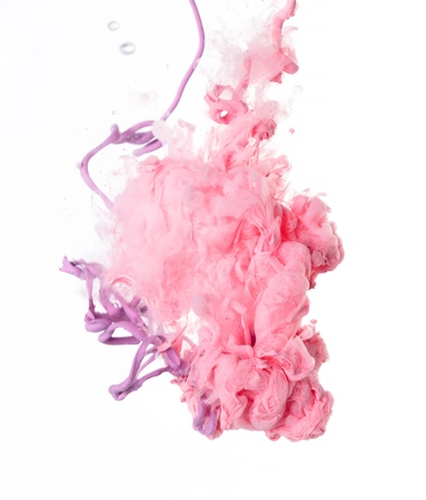 Pink acrylic color in water on white backgroundの写真素材
