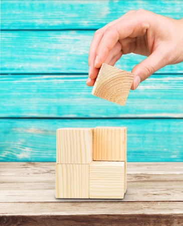 "lets build it" or hand holding wooden blockの写真素材