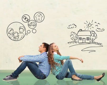 concept. young happy family couple dreaming of new house, car, child, financial well-beingの写真素材
