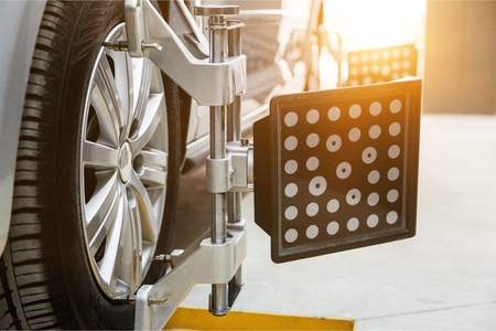 Car in garage of auto repair service shop with special repairing equipment