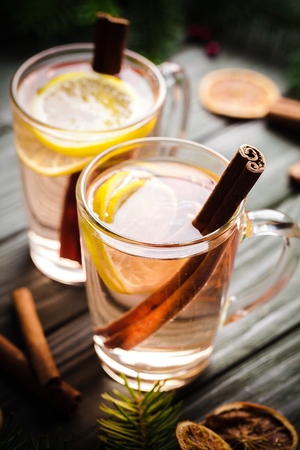 Two Toddy Cocktail Drinks with Cinnamon on Rustic Woodの写真素材