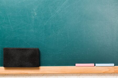 Blank blackboard with chalk and eraser.の写真素材