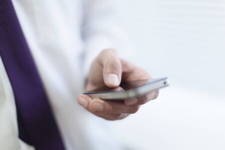 close up hands multitasking man using tablet, laptop and cellphone connecting wifiの写真素材