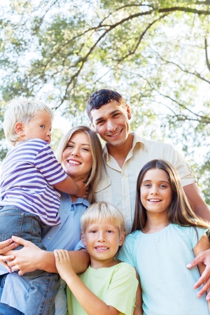 Group of happy smiling people against blue sky