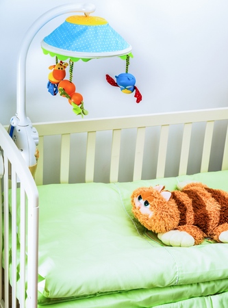 A soft toy on a baby crib in the baby bedroomの写真素材