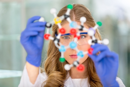 A teacher in a chemistry lab analyzing molecular structure of dmtの写真素材