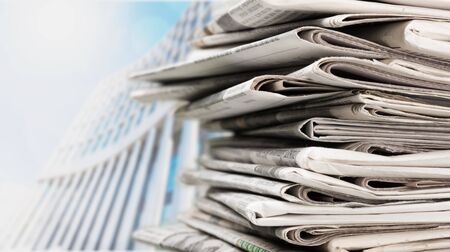 Pile of printed newspapers on backgroundの写真素材