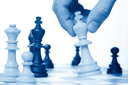 A Hand Holding King on a Chessboardの写真素材