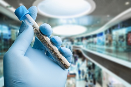 Tube with plant in handの写真素材