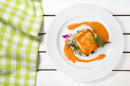 Grilled Salmon Steak  with Spinach, Tartare Cream and Lemon Wedgesの写真素材