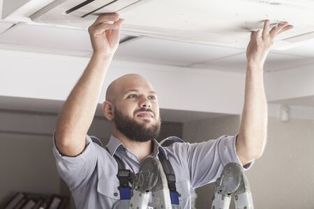 Young Happy Male Technician Gesturing Thumb Up