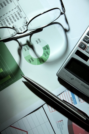 Pen, Glasses And Calculator On Financial Reports Close-upの写真素材