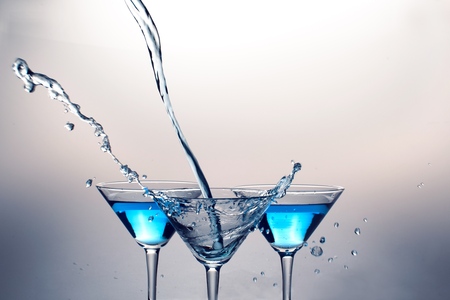 Martini Being Poured From Afar And Martini Drinks in Backgroundの写真素材