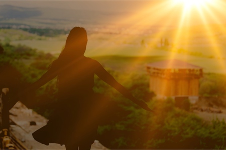 Woman thanks God in mountainの写真素材