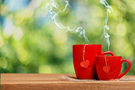 Two red mugs on tableの写真素材