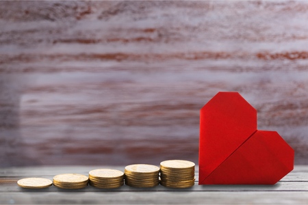 Coin stack and red heart