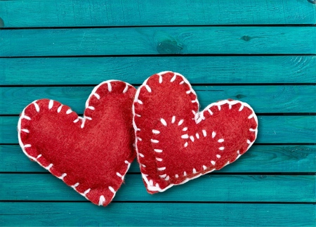 Love heart hanging on wooden texture backgroundの写真素材