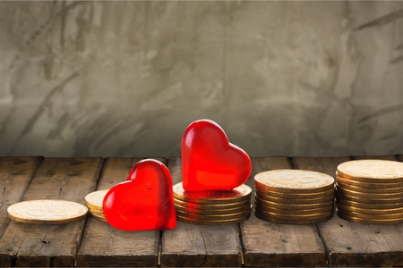 Coin stack and red heartの写真素材