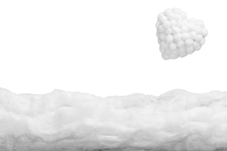 Two small clouds pouring rain over two mushrooms and a white heart, in a heavenly scenery where the clouds  are made from cotton-wool, on a blue sky paper background.の写真素材