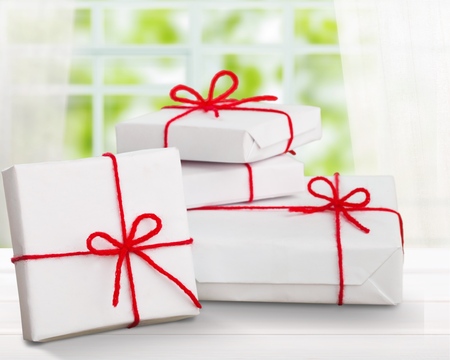 present boxes and red heart on table