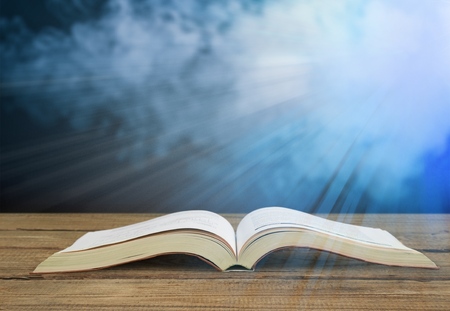 Open Bible on a wood table with light coming from above. ( Church concept. )の写真素材