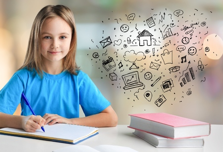 happy asian elementary school student studying in classroom looking at camera smiling,の写真素材