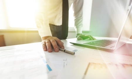 Double exposure of businessman hand working with new modern computer and business strategy as conceptの写真素材