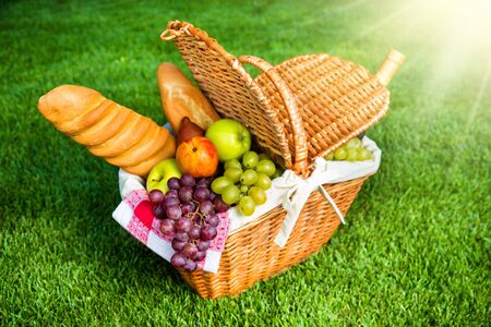 Picnic Basket On Grass In Parkの写真素材