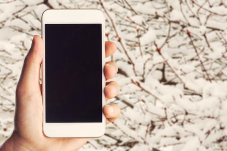 hand holding phone mobile isolated on white background clipping path insideの写真素材