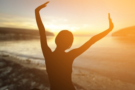 Back view of strong motivated woman celebrating workout goals towards the sun. Morning healthy...