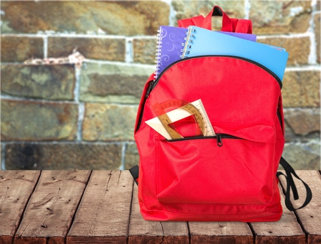 Backpack on wooden tableの写真素材