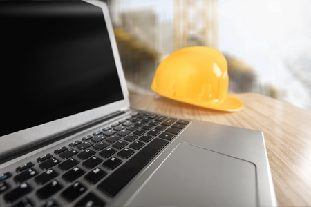 Yellow helmet with equipment on wooden table backgroundの写真素材