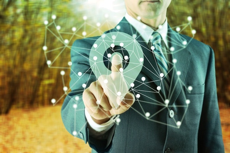 Businessman pressing button screen and selecting contact us network pointer.の写真素材