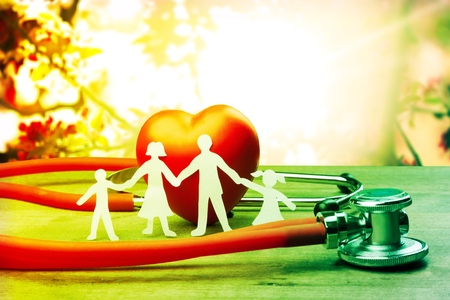 Medical Insurance Concept With Family Cut-out And Stethoscope On Wooden Deskの写真素材