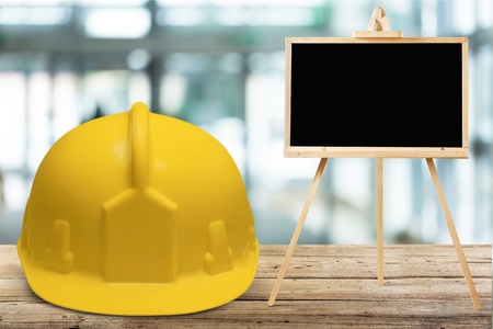 Safety helmet and black boardの写真素材