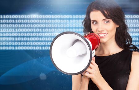Pretty girl shouting into megaphone on copy spaceの写真素材