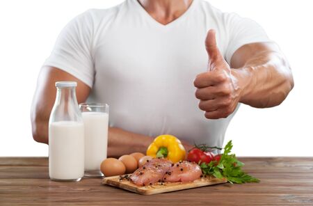 healthy eating, balanced diet, food and people concept - close up of male hands having meat and vegetables for dinner with fork and water glassの写真素材