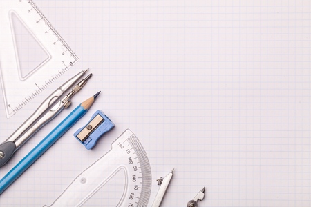 Mathematical instruments surrounding a graph paper creating copy spaceの写真素材