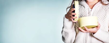 Child hands opening gift boxの写真素材