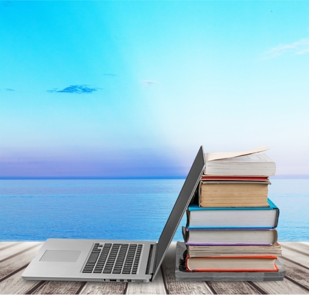 Stack books with laptop on tableの写真素材