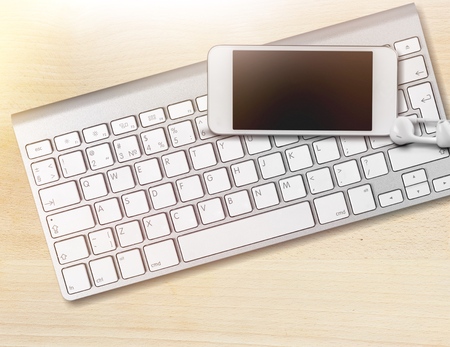 Keyboard and phone on deskの写真素材