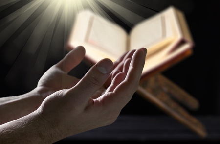 Muslim man hands holding rosary with quraanの写真素材